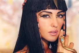 Classic Egyptian eye makeup... defining the eye, adding embellishment at the outer corner of the eye.