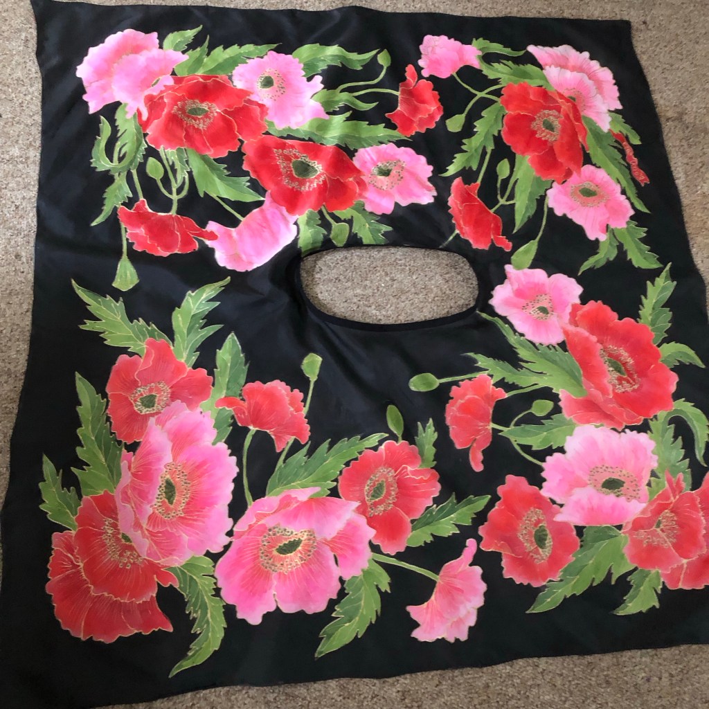 This cape measures 4 ft square and is hand painted habotail silk.