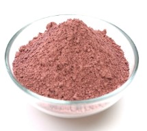 A bowl filled with a mound of reddish-brown powder.