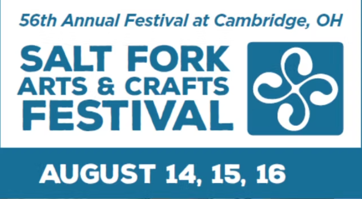 A bunch of fresh lemongrass stalks placed on a wooden surface.